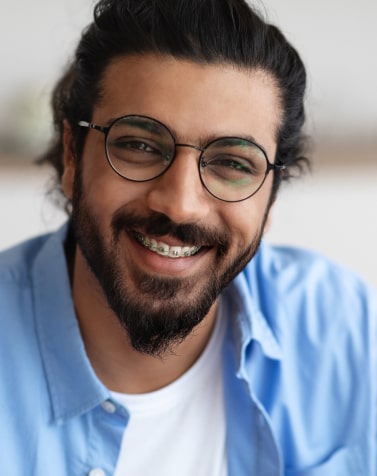Man with a beard in glasses smiling